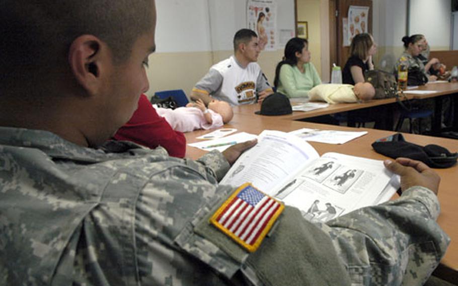 Pfc. Victor Ruiz, an expecting father enrolled in Baumholder's new parents course, studies up on what to expect during his wife's delivery.