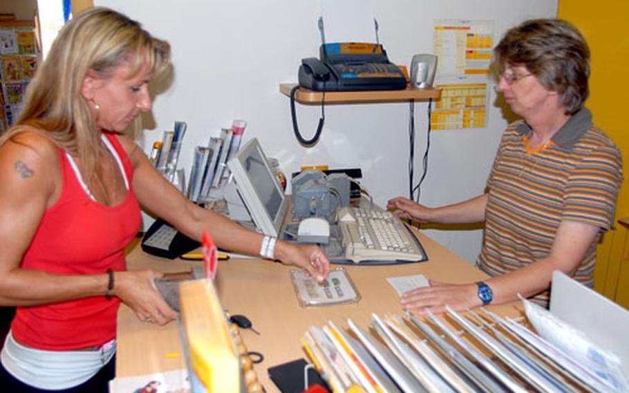 Benigna Coleman, left, a 2nd Cavalry (Stryker) Regiment spouse, shops at a store owned by Sieglinde Goppner in Vilseck, Germany. Vilseck businesses expect less income while the regiment is in Iraq.