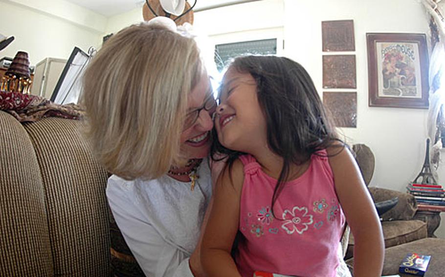 Lynsey Ferris and her daughter Olivia, 3, share a laugh in their home on the U.S. Navy support site in Gricignano near Naples, Italy.
