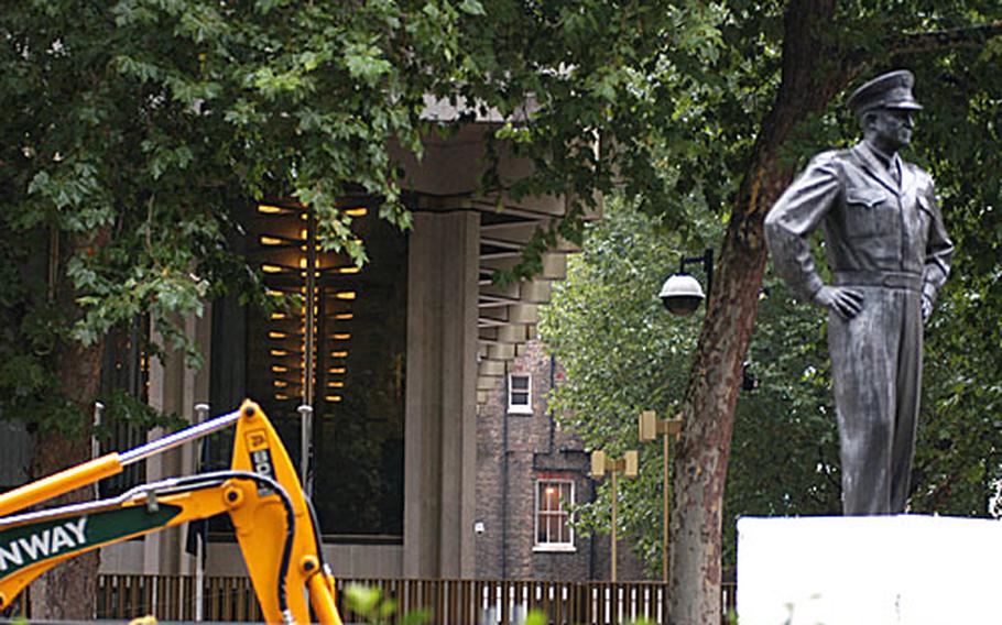 A statue of Gen. Dwight Eisenhower stands watch outside the U.S. Embassy in London as an excavator works on the new security perimeter.