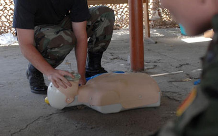 U.S. Air Force Senior Airman Daniel Lowe keeps a watchful eye on his students while instructing cardiopulmonary resuscitation class during a multinational medical training exercise.