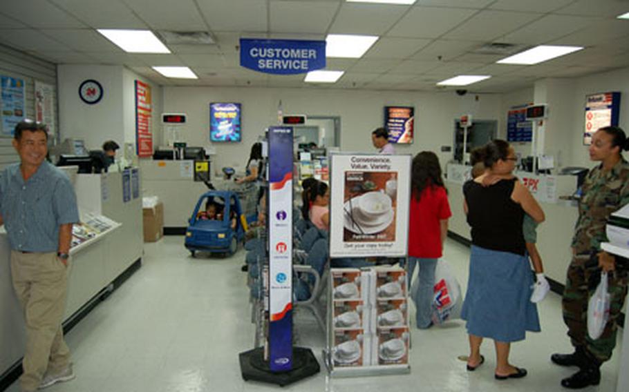 Army and Air Force Exchange Service customers wait in the customer service section of the Yongsan Garrison store on Wednesday. AAFES officials confirmed this week that they reduced layaway options, saying the program wasn’t cost effective; they didn’t have enough storage space; the items were often damaged while in storage; and usage has declined with more customers preferring to use credit.