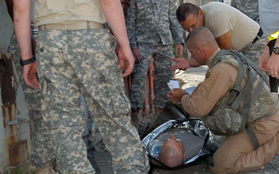 Staff Sgt. William Mudd, a combat medic with the 82nd Airborne Division, tends to a soldier who is stricken with malaria. Mudd's unit has made about a half-dozen emergency runs in the past several months to retrieve troops inflicted with the virus.