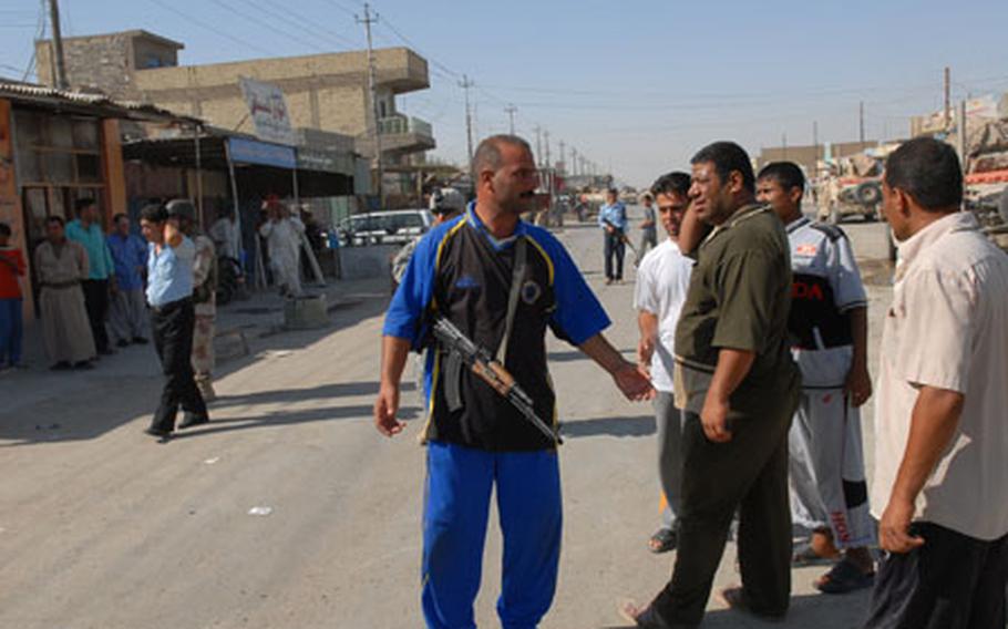 An armed guard belonging to a group of Sunnis called "Volunteers" helps provide security in Nasr Wa Salam, Iraq, a former al-Qaida stronghold in Iraq, during a visit by a Shiite government official last month. They are one of the groups of Iraqis working with coalition forces to provide protection in their own neighborhoods.
