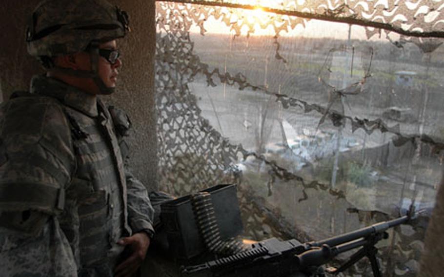 Spc. Mario Martinez, 26, of Big Lake, Texas, stands sentry at sunset on Wednesday evening atop the roof of Combat Outpost Sullivan in the eastern Baghdad neighborhood of Zafaraniyah, which lies in the city district of Karadah. The soldier is a member of the 2nd Infantry Division, 2nd Brigade, 2nd Battalion, 17th Field Artillery Regiment, based out of Ft. Carson, Colo.