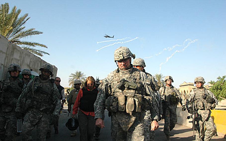Col. Bannister leads troops and a small group of journalists to the Mutannabi Street book in eastern Baghdad market on Sunday. Apache helicopter gunships drop flares to draw off possible surface-to-air missles as they fly overhead.