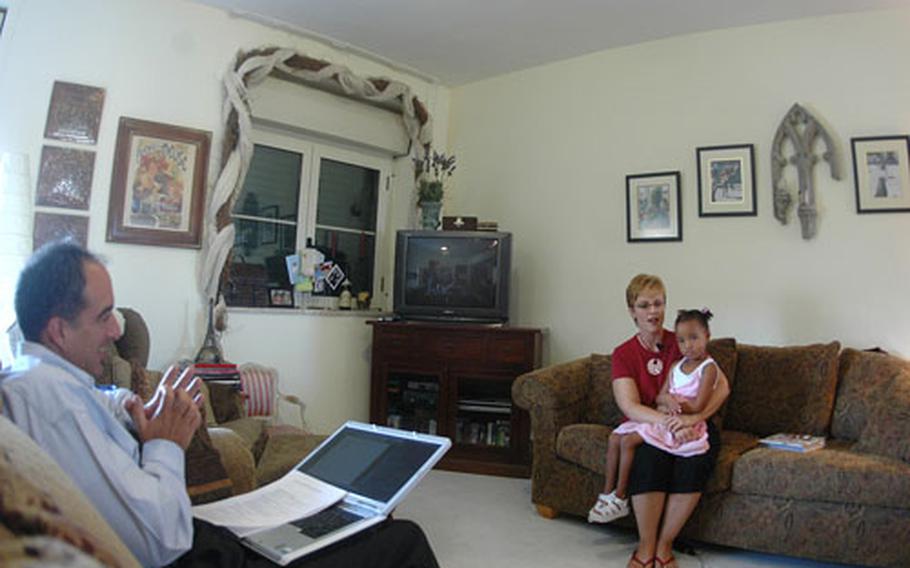 Jo-Ann Reale, with daughter Bella, 3-1/2, talks on camera about the warm community atmosphere she found in the military. She was interviewed by the public affairs office of Navy Installation Command.