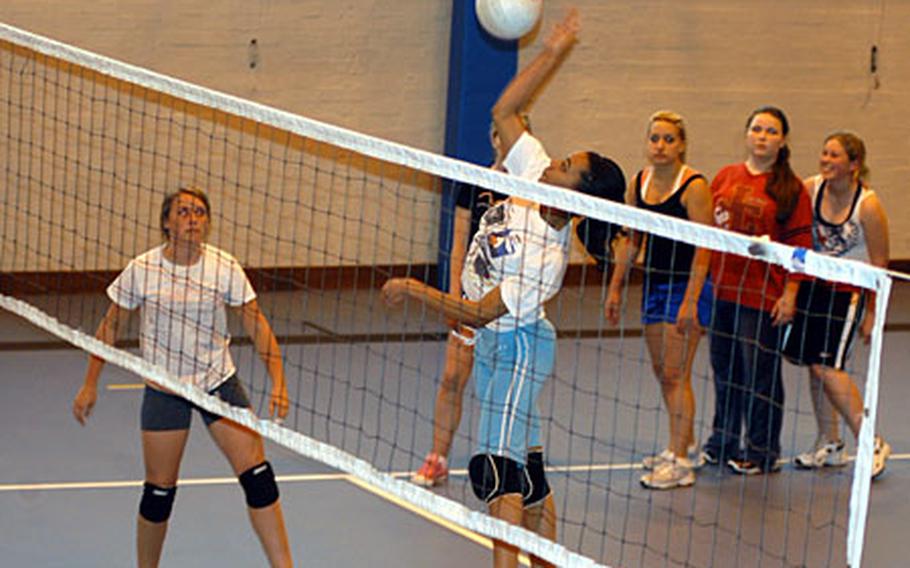 Lakenheath junior Shannon Scott spikes a volleyball as other teammates watch on during practice last week.