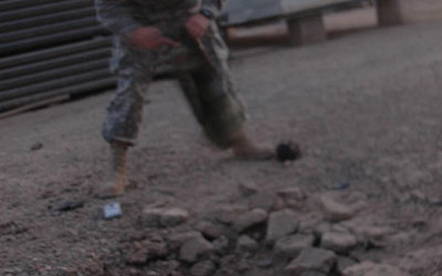 Spc. Horacio Proa, 22, of Delray Beach, Fla., responds to a rocket attack on FOB Loyalty on Wednesday at dawn. He works with units on the base who fire 120 mm mortar shells. "If we can, we usually shoot back," he said. No one was injured in the attack.