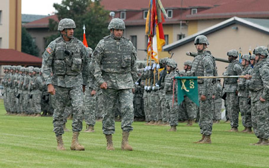 Maj. Gen. Mark Hertling, left, 1st Armored Division commander, and Lt. Gen.Kenneth Hunzeker, V Corps commander, inspect the troops at the departure ceremony for the 1st AD headquarters staff and attached units at Wiesbaden Army Airfield, Germany, on Thursday. The units will begin deploying to Iraq next week.