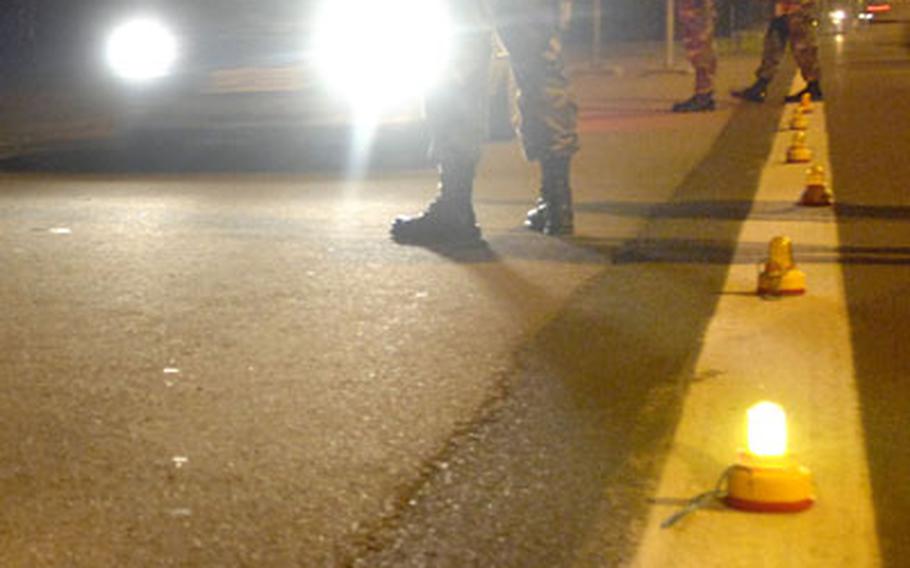 Werner Pfirrmann, a civilian local national from the 435th Security Forces Squadron, stops a vehicle at a DUI check-point just outside Ramstein Air Base’s west gate Aug. 26th. Statistically speaking, those living or working at U.S. Air Forces in Europe bases face a lot less crime than similar-sized populations in the States.