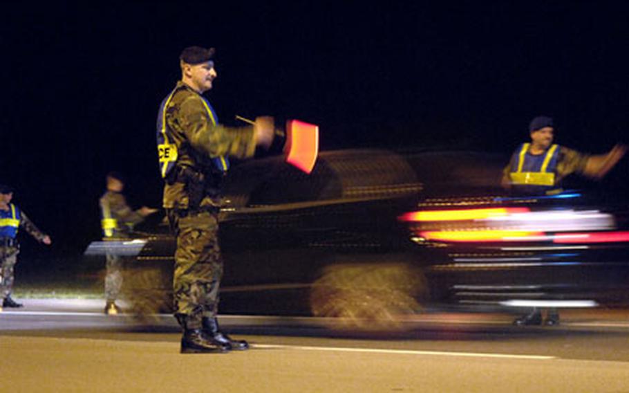 Tech. Sgt. Michael Roberts, a flight chief from the 435th Security Forces Squadron, accompanied by Michael Benesch randomly pull over vehicles outside Ramstein Air Base’s west gate Aug. 26th as part of a crackdown on DUIs.