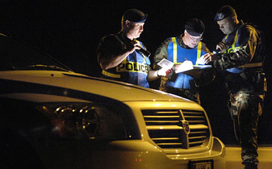 From left, Werner Pfirrmann, Tech. Sgt. Zeb Handeland and Matthias Keiser, all from the 435th Security Forces Squadron, check IDs at a DUI checkpoint just outside Ramstein Air Base’s west gate Aug. 26th.