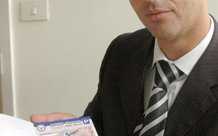 Bart Di Muccio, administrator of the tax-free office, which runs the gas-coupon program for U.S. and NATO commands in Italy, holds samples of the new coupons that will go on sale at U.S. and NATO bases in Italy starting Oct. 1.