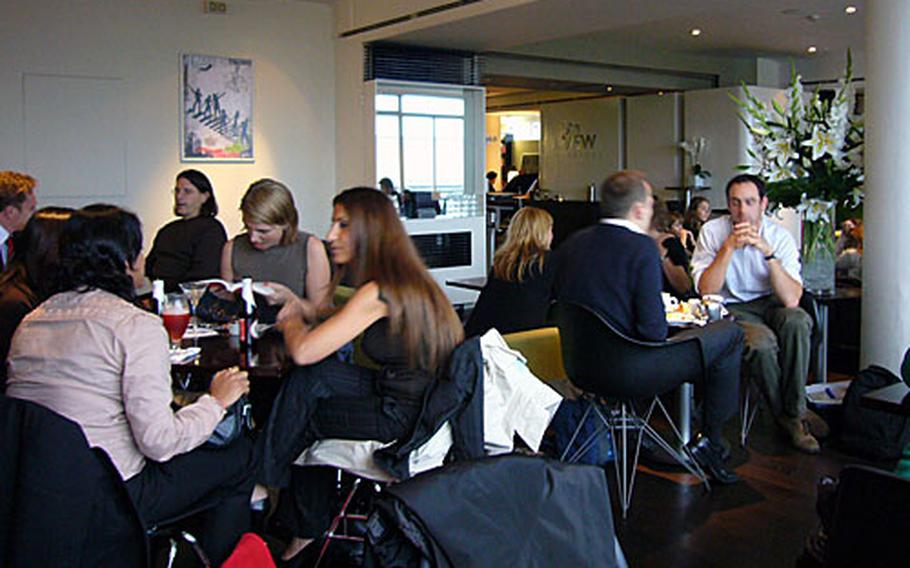 Patrons of the 5th View Bar enjoy some drinks in an informal atmosphere. The bar is inside the Waterstone's book store in the heart of London's West End.