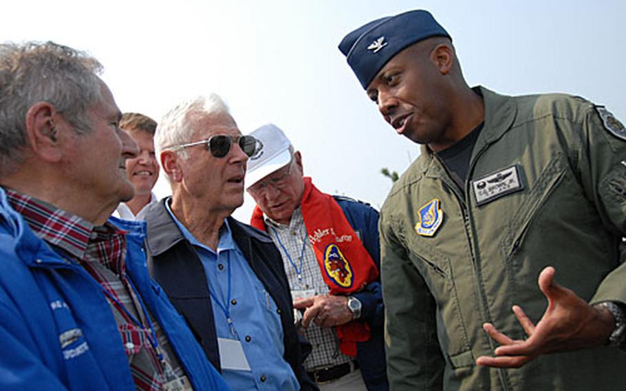 Col. C.Q. Brown, right, commander of the 8th Fighter Wing, talks with Korean War fighter pilots Ralph Gibson, Charles Cleveland, and Wilbur "Pete" Carpenter about Kunsan Air Base, South Korea.