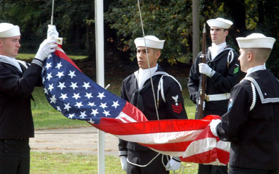 Sailors from U.S. Naval Activities United Kingdom cased the flag for the last time Friday at RAF Daws Hill, west of London, at the end of a disestablishment ceremony for USNAUK.