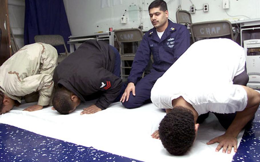 Sailors aboard the USS Saipan pray during a Muslim religious service in 2003, while deployed in support of Operation Enduring Freedom. Muslim troops say the U.S. military community has been tolerant of their religion, and they have been able to coordinate Ramadan observances with their supervisors.