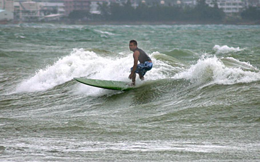 Surf's up for a local who takes advantage of the waves generated Friday afternoon by the approaching Typhoon Nari at a beach off Route 75 near Camp Courtney, Okinawa.