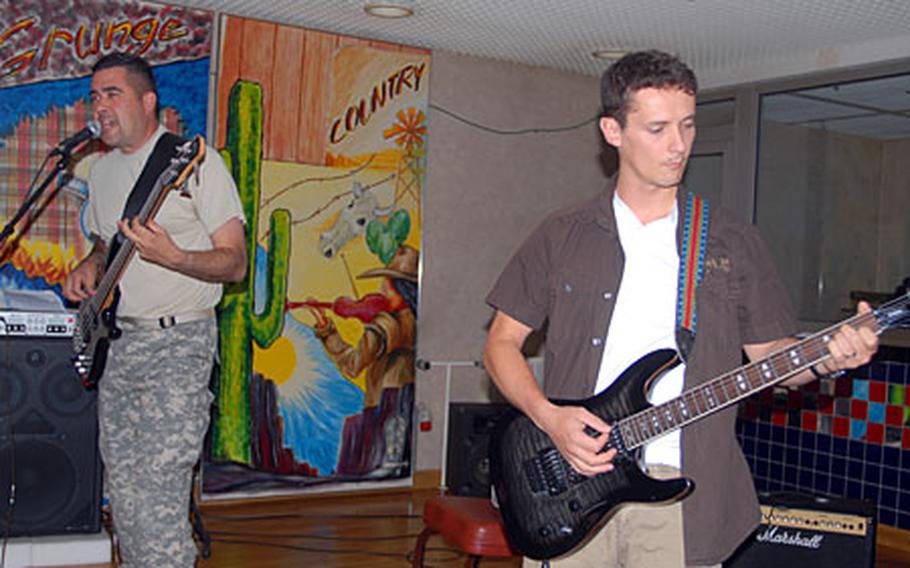 Expats bassist Mathew Cervantes, left, and guitarist Adam Schlang honed their musical skills in Iraq and Afghanistan.