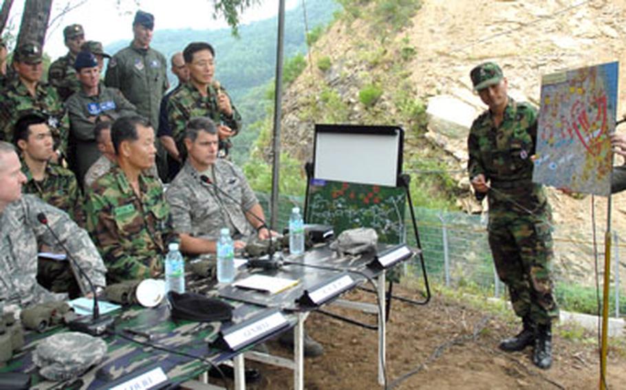 U.S. Forces Korea commander Gen. B.B. Bell, left, South Korean Gen. Kim Byung-kwan and other U.S. and South Korean military leaders discuss the tactics that helped U.N. forces win the battle of Hangyeri. Participants attended a "Staff Ride" that took them to Hangyeri and Hongcheon Pass, where the battle was fought in May 1951.