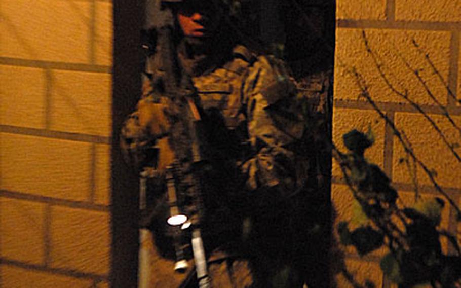 A soldier with the 5th Battalion, 82nd Field Artillery Regiment, 4th Brigade, 1st Cavalry Division is watchful during a raid in the township of Aitha in northern Iraq on Sept 16.