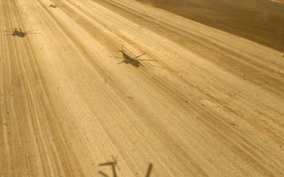Shadows of MH-53M Pave Low helicopters cast down on a dirt farmfield during a final flight across the English countryside. Five Pave Lows from the 21st Special Operations Squadron, which will inactivate next month, conducted a final flight.