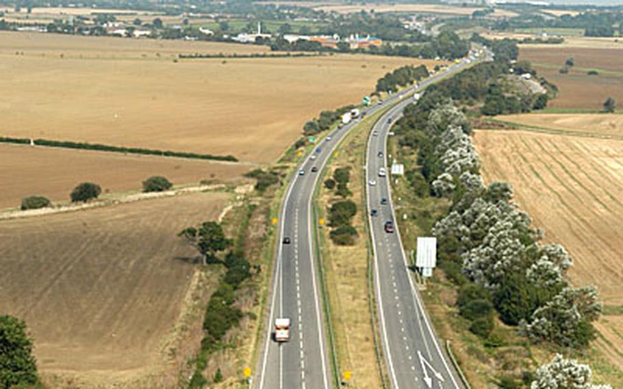 A MH-53M Pave Low helicopter crosses over a highway along a final flight. The squadron is based at RAF Mildenhall.