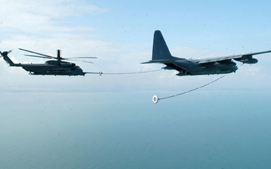 A MH-53M Pave Low, part of a five-helicopter formation, is refueled by a MC-130P Combat Shadow during the helicopter&#39;s final flight.