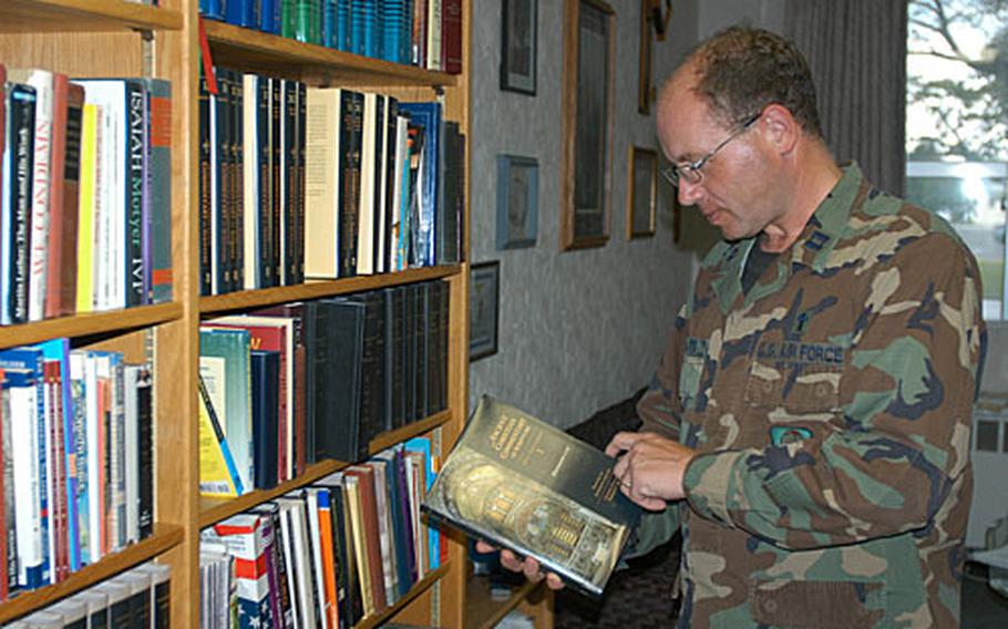Air Force chaplain, Capt. Matthew Boarts, leafs through a book in his office at the Four Chaplains Warfighter Center of Excellence.