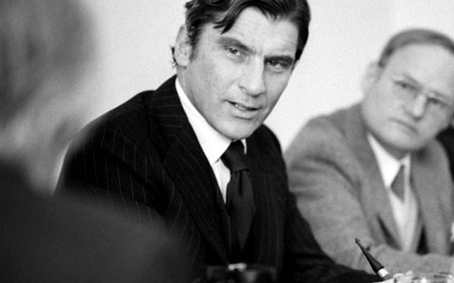 Secretary of the Navy John Warner takes part in a discussion during a visit to Kaiserslautern, Germany, in October, 1973.