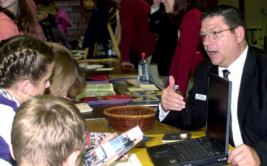 Bob Broshous, right, a representative from the University of Dubuque, talks to prospective college students about attending the university at Kaiserslautern College Information Night in 2006. The event drew such a large crowd, it will be moved to the Special Events Center on Rhine Ordnance Barracks this year. Several other high schools will be running buses to the fair, planned for Oct. 18.