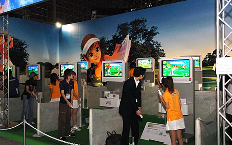 Japanese visitors play Capcom’s “Wii Love Golf” video game at the 2007 Tokyo Game Show.