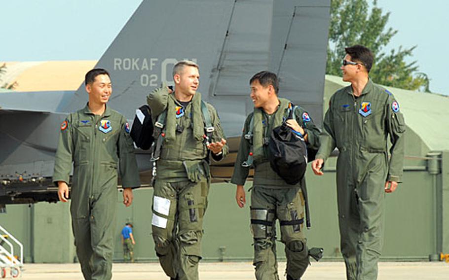 Maj. Craig Vincent walks with a group of South Korean pilots he trained in South Korea. Vincent spent nine months here instructing the South Korean Air Force on their recently acquired F-15K.