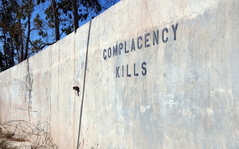 A sign at Camp Baharia in Anbar province warns troops against being lulled into a false sense of security.