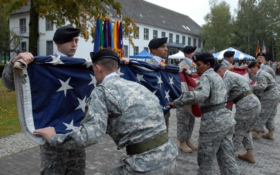 Soldiers from U.S. Army Garrison Hessen fold the flag for the last time in Giessen, Germany, at the closure ceremony for the garrison.