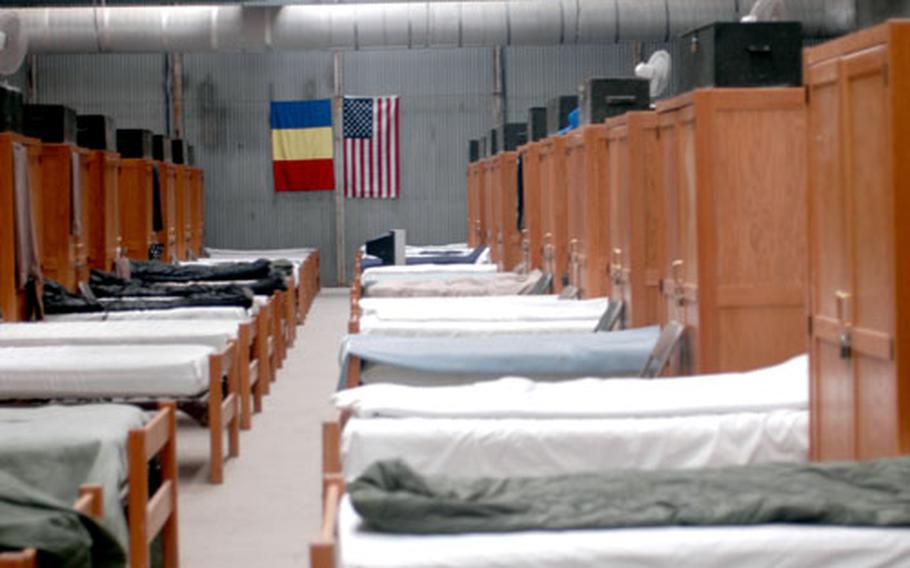 Some 70 soldiers sleep in each of the portable buildings brought to Mihail Kogalniceanu air base in Romania from Kosovo. Romanians training with U.S. soldiers sleep there as well. Their cots have noticeably fewer pairs of shoes underneath.