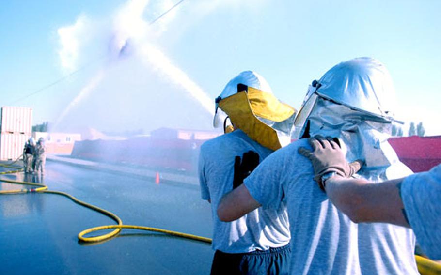 A firefighting competition allows other Air Force personnel to test their mettle in a hose competition against military firefighters on Manas Air Base on Sunday. The competition pitted teams against each other in a test to control the water pressure from the hose to push a heavy canister across a cable.