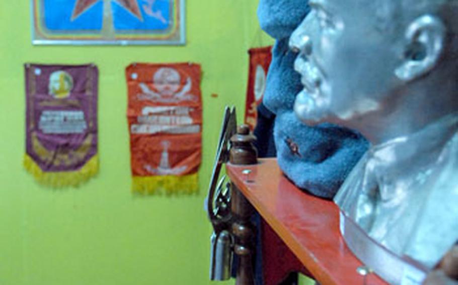 A bust of Vladimir Ilyich Lenin rests atop a shelf along with other trinkets at a gift shop in a cafe on Manas Air Base, Kyrgyzstan.