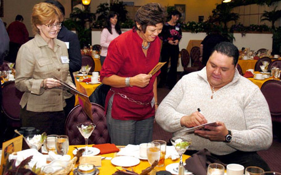 Chad Rowan, better known as Akebono, signs autographs for members of the Yokota Officers Spouses Club.