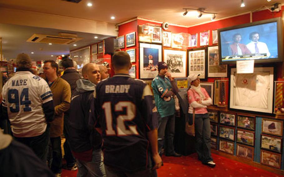 Sports fans cram into the First Class Sports Bar to watch a few NFL games following the Miami Dolphins and New York Giants match up at nearby Wembley Stadium last month.