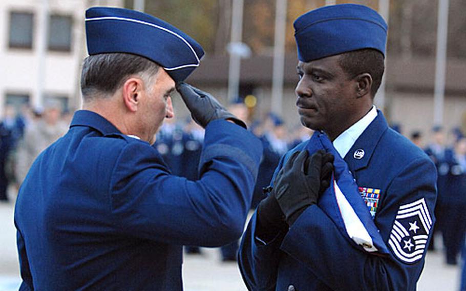 Gen William T. Hobbins, U.S. Air Forces in Europe commander, salutes the flag after presenting it to USAFE Command Chief Master Sgt. Gary G. Coleman during a retreat ceremony. The retreat ceremony followed a retirement ceremony honoring Coleman for 30 years of military service.