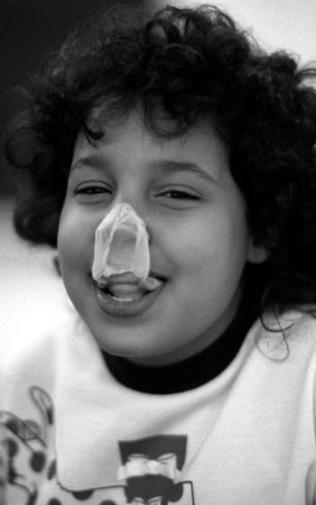 Angela Duke smiles after a bubble made an emergency landing on her nose.