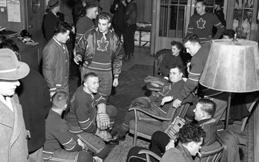 Players from the Canadian Flyers hockey team wait in a German hotel lobby before leaving for the rink in 1954.