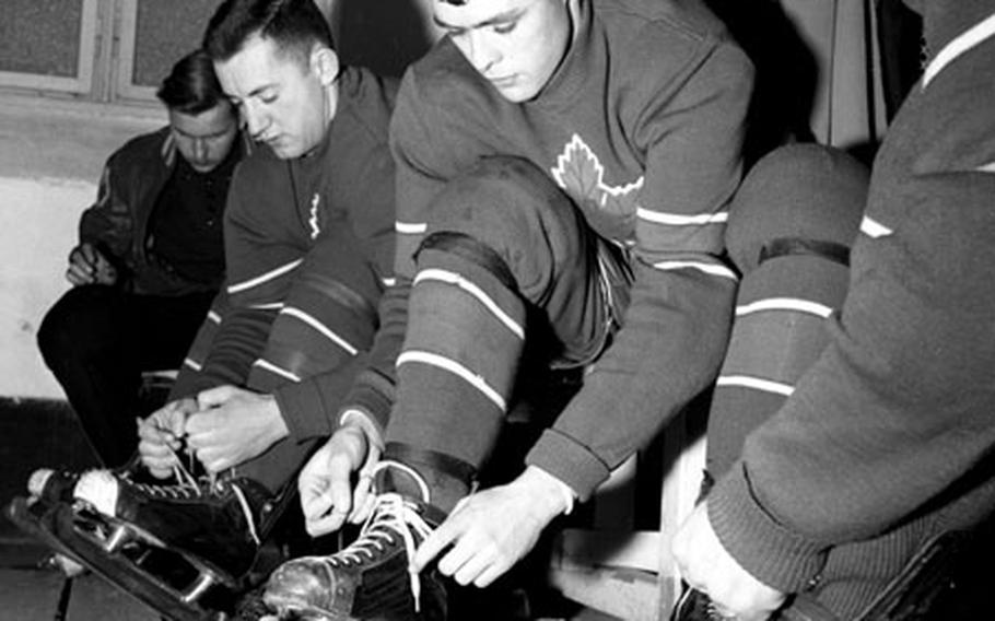 Players prepare to head out onto the ice for a game at Munich.