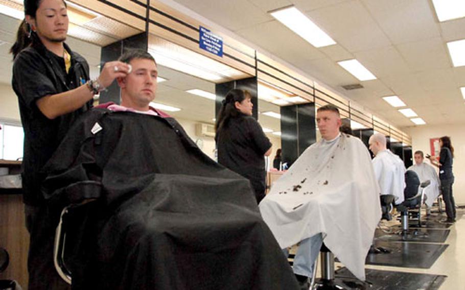 Haircuts continue as usual Friday at the barbershop on Sasebo Naval Base despite a Japanese labor strike.
