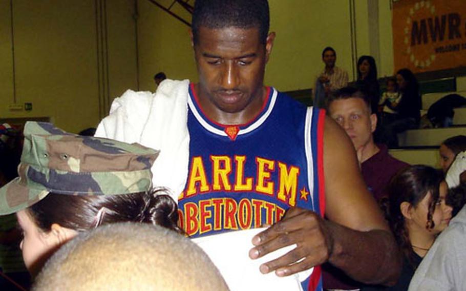 Paul "Showtime" Gaffney signs autographs for fans after the Harlem Globetrotters game Friday night at Naples High School auditorium in Gricignano.