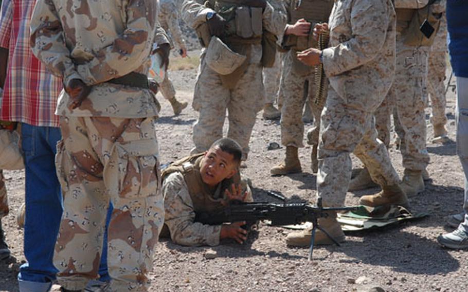 Lance Cpl. David Jaime, 21, of Santa Maria, Calif., demonstrates to the gathered members of the Djiboutian air force how to use a squad automatic weapon at a joint exercise on Dec. 2 near Arta, Djibouti.