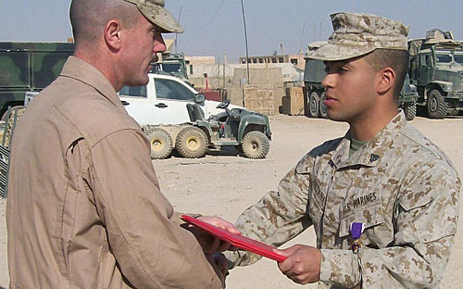 Cpl. Yoen Santana, right, from Queens, N.Y., receives a Purple Heart in Anbar province, Iraq, in August after he was wounded in the upper shoulder from a celebratory round of gunfire. He was the only Marine with the truck detachment, from 3rd Marine Division, to receive a Purple Heart during the detachment's recent deployment.