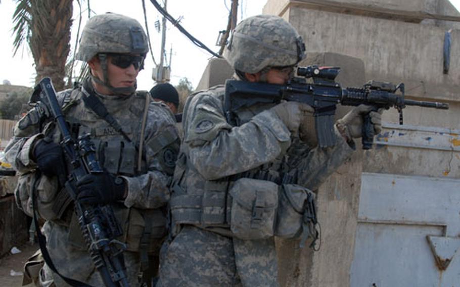 Third Squadron, 2nd Cavalry (Stryker) Regiment soldiers watch for trouble during a patrol in southern Baghdad&#39;s Hadar neighborhood on Tuesday.
